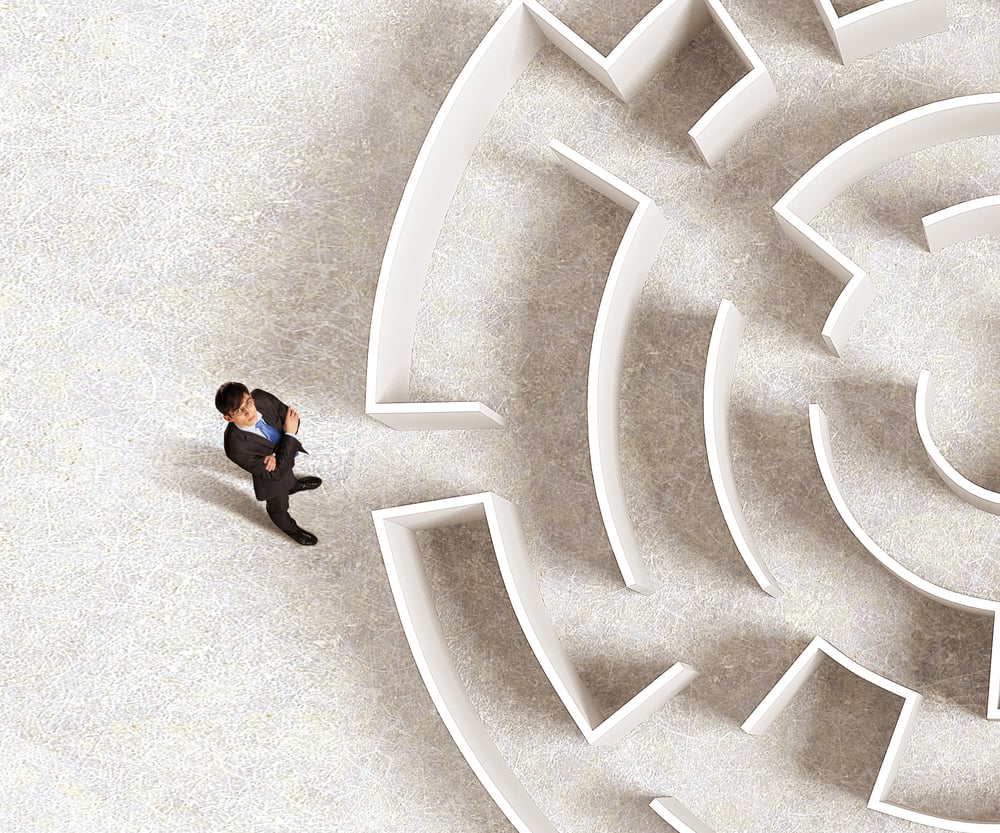 Top view of successful businessman standing near the entrance of labyrinth Top view of successful businessman standing near the entrance of labyrinth